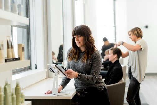 A female small business owner organizing her business while working on a tablet